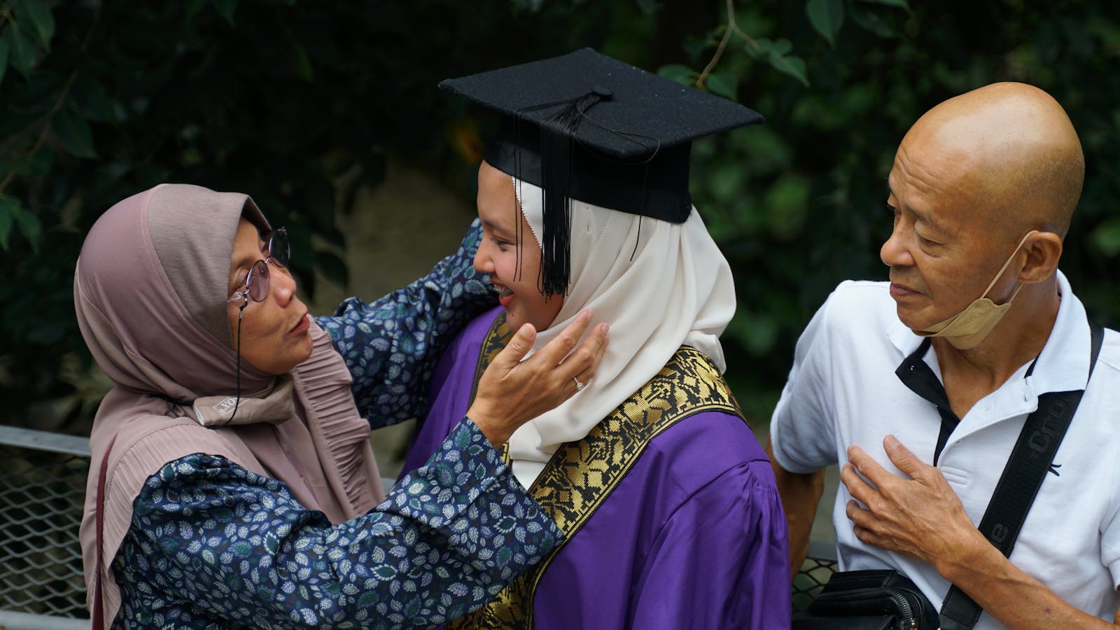Family celebrating their daughter's graduation in Malaysia